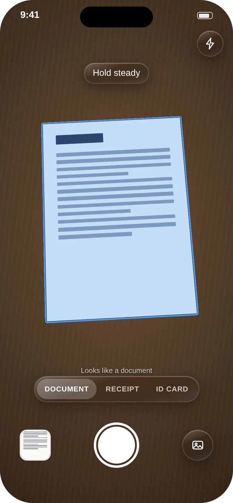 CrispCopy camera screen with a letter on a desk, its edges outlined in blue and a Hold steady prompt above it